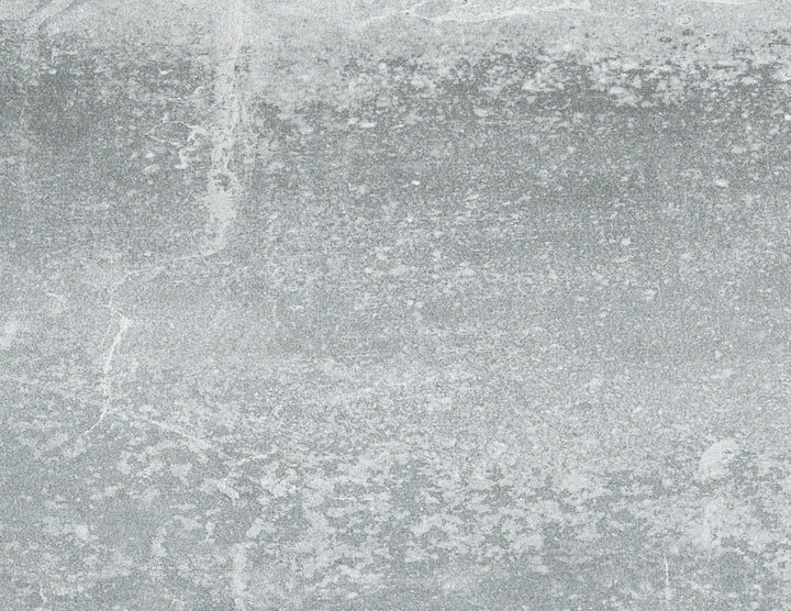 Textured gray concrete surface with various shades and mottled pattern, displaying the natural weathering and aging of the material.