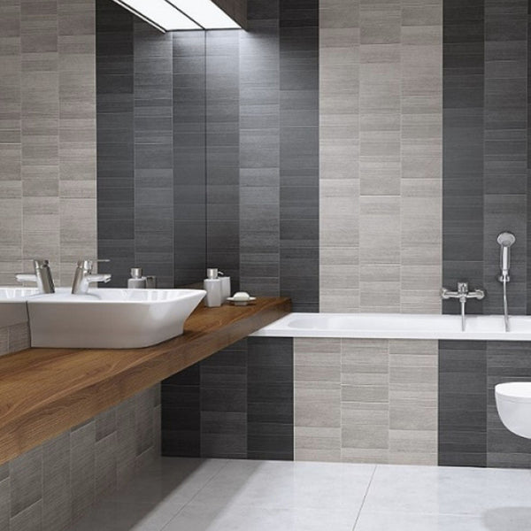 Modern bathroom interior with dual sinks, wooden countertop, large mirror, tiled walls in shades of gray, bathtub, and minimalist design elements.